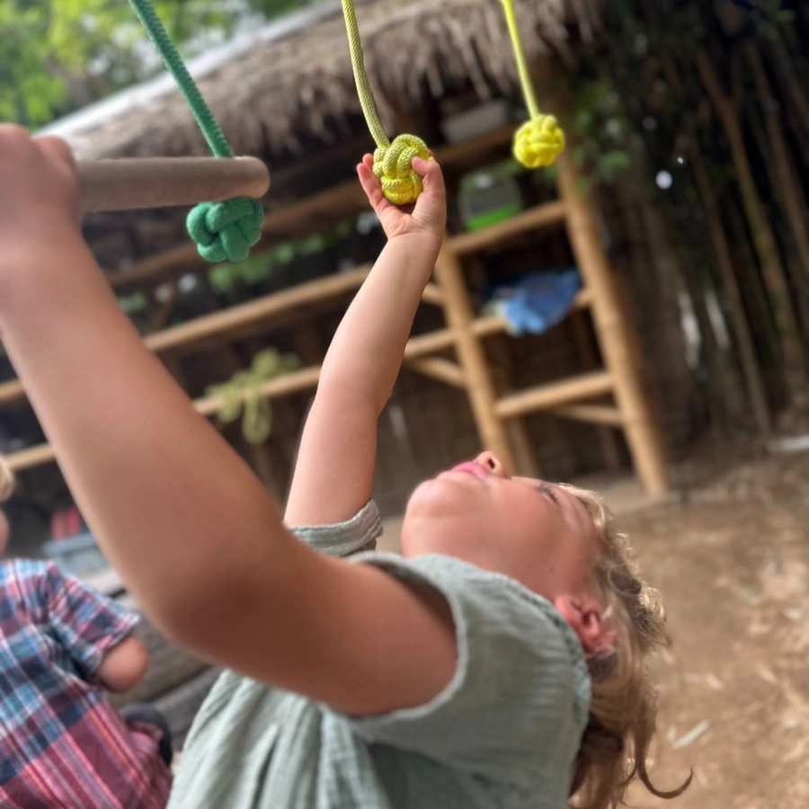 Facilitator supporting a child on the climbing wall